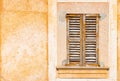 Old brown wood window shutter with rusti plaster wall background Royalty Free Stock Photo