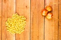 Detail view of onion, macaroni and pasta on wooden background, top view, copy space for text, close up photo Royalty Free Stock Photo