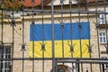 A detail view of a portion of a wrought iron gate with Ukrainian flag on a background Royalty Free Stock Photo