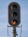 Detail view of a railway high light signal traffic light on a pole giving the lower indication of orange color on yellow stop Royalty Free Stock Photo