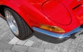 Detail view, from the right front corner of a red sports car with folding headlights, indicators,. bumper and a part of the front Royalty Free Stock Photo
