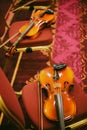Two violins on some chairs Royalty Free Stock Photo