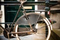 Detail of vintage old rusty bicycle parked in front of Dutch house