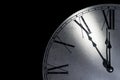 Detail of a vintage wall clock showing five minutes to midnight as a symbol for time running out Royalty Free Stock Photo