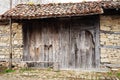 Detail of vintage wooden door, stone wall