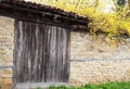 Detail of vintage wooden door, stone wall