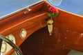 Detail of vintage wooden speed boat with crystal vase in vase holder with a red rose Royalty Free Stock Photo