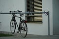 Detail of a visitors bicycle parking place in front of a residential building with a parked and locked bike as an example. Royalty Free Stock Photo