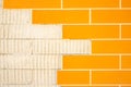 Detail of a wall with ceramic tiles imitating orange bricks. Royalty Free Stock Photo