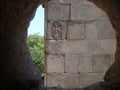 Graven Armenian cross seen by a stone window, Armenia. Royalty Free Stock Photo