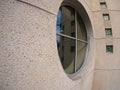 Detail of a wall of an office building with a round window Royalty Free Stock Photo