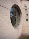 Detail of a wall of an office building with a round window Royalty Free Stock Photo
