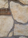 Detail of a wall with stones in various shades of beige.