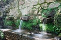 Detail of the water flowing in the fountain called the three pipes in the Monfrague National Park Royalty Free Stock Photo