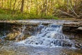 Detail of waterfall over slates of rocks in fall forest Royalty Free Stock Photo