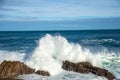Detail of waves breaking on the rocks of the coast of San Sebastian, Spain, Europe. A sunny day