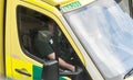 Detail of a Welsh ambulance cab and paramedic.