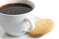 Detail of a white ceramic cup of black coffee with shortbread bi Royalty Free Stock Photo
