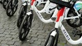 Detail of white HELBIZ electric bicycles, for rent on the streets of Rome. an Italian-American intra-urban transport company based Royalty Free Stock Photo