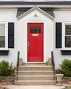A detail of a white home s red front door. Royalty Free Stock Photo