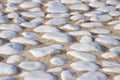 Detail of a white rounded pebble floor with white polished stone into a concrete subfloor Royalty Free Stock Photo