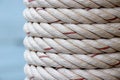Detail of white ship rope wrapped around the pole at fishing port Royalty Free Stock Photo