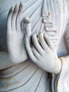 Detail of a white statue of the Buddha with his hands. Fingers in mudra Royalty Free Stock Photo