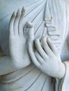 Detail of a white statue of the Buddha with his hands. Fingers in mudra Royalty Free Stock Photo