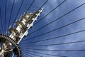 Detail of a white steel spiral staircase structure with wire cables