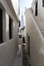 Detail of the white streets of Binibeca with a church in the background, Menorca, Spain