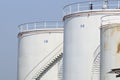 detail of white tanks in tank farm with iron staircase Royalty Free Stock Photo