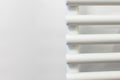 detail of a white tubular radiator on a white wall. heating in tubular steel. interior of a new home Royalty Free Stock Photo