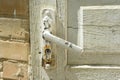 Detail of white vintage wooden door with a painted cracked door handle Royalty Free Stock Photo