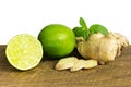 Detail of whole and cut fresh ginger with lime Royalty Free Stock Photo