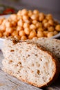 Detail of wholewheat bread in front of bowl with chickpeas