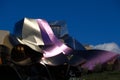 Detail of the wine colored metallic corrugated structures of a building designed by the architect Frank O. Gehry, for