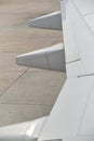 Detail of a wing of a commercial passenger airplane parked Royalty Free Stock Photo