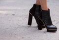 Detail of woman footwear on the street black booties Royalty Free Stock Photo