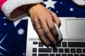 Detail of woman hand using a white mouse over a laptop keyboard. Business concept, close up Royalty Free Stock Photo