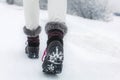 Detail of woman lifting her black and gray snow boot Royalty Free Stock Photo