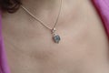 Woman neckline wearing apatite mineral stone pendant on silver chain