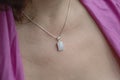Woman neckline wearing moon stone mineral stone pendant on silver chain