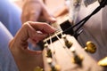 detail of a woman\'s hands playing the strings of a ukulele. Close-up and in focus of the hand and out of focus effect of the Royalty Free Stock Photo