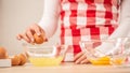 Detail of woman`s hands separating egg yolks from the whites into two glass bowls Royalty Free Stock Photo