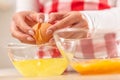 Detail of woman`s hands separating egg yolks from the whites into two glass bowls Royalty Free Stock Photo