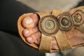 detail of a woman& x27;s foot in a summer sandal with three decorative medallions Royalty Free Stock Photo