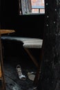 Detail of wooden cottage, entrance of empty hut with a pair of women`s shoes on floor