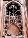 Detail of wooden door of a building on the street with an iron decorative ornament. Old Tbilisi architecture Royalty Free Stock Photo