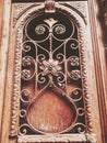 Detail of wooden door of a building on the street with an iron decorative ornament. Old Tbilisi architecture Royalty Free Stock Photo