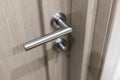 Detail of wooden door. Door handle close-up with blurred background. Royalty Free Stock Photo